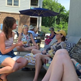 women relaxing near a pool
