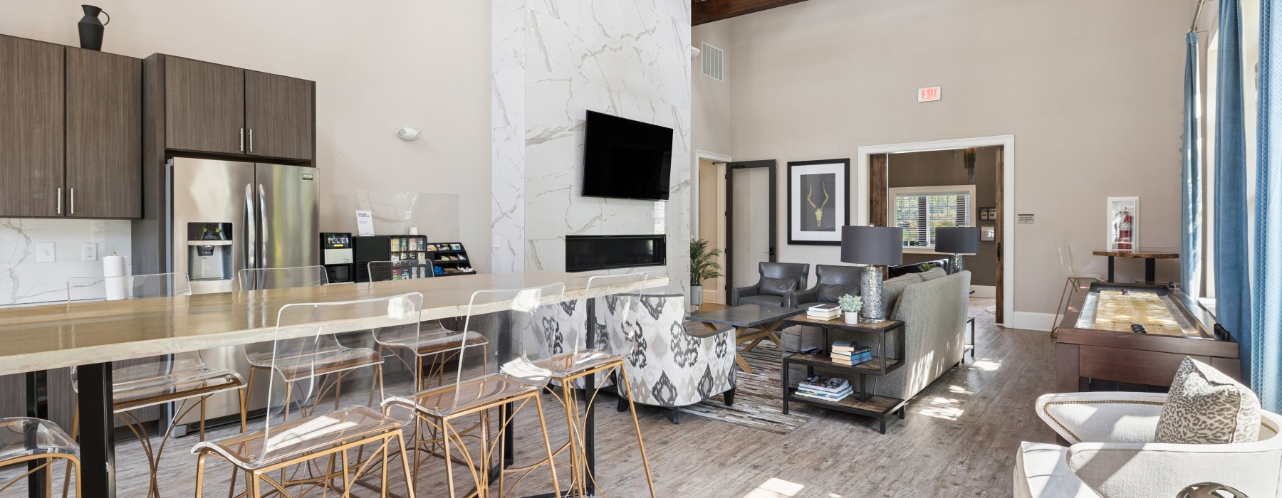 a clubroom with a couch, tv and chairs