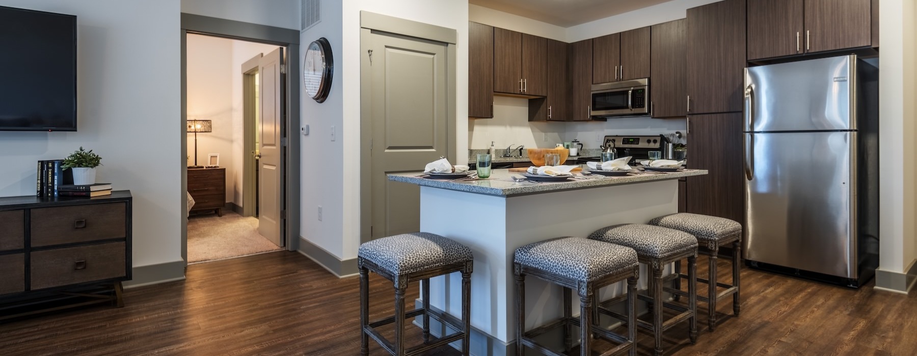 a kitchen with a bar stool and a table
