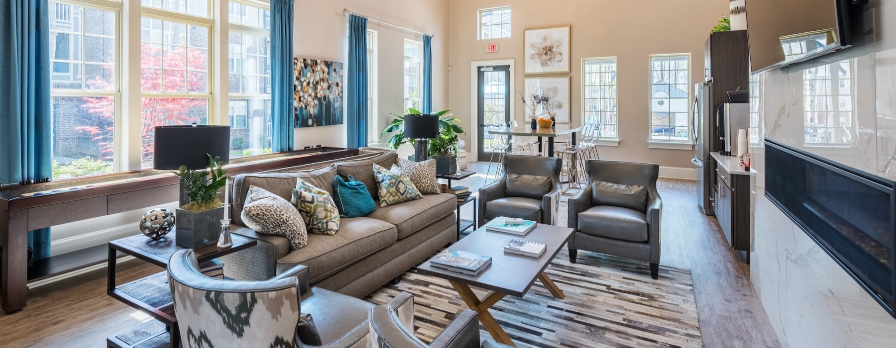 a clubroom with a couch, tv and chairs