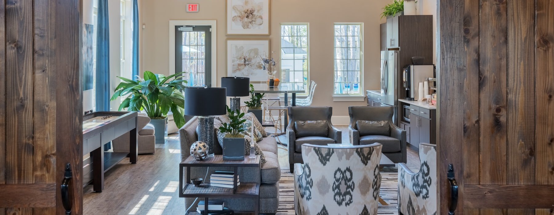 a clubroom with a couch, chairs and tables
